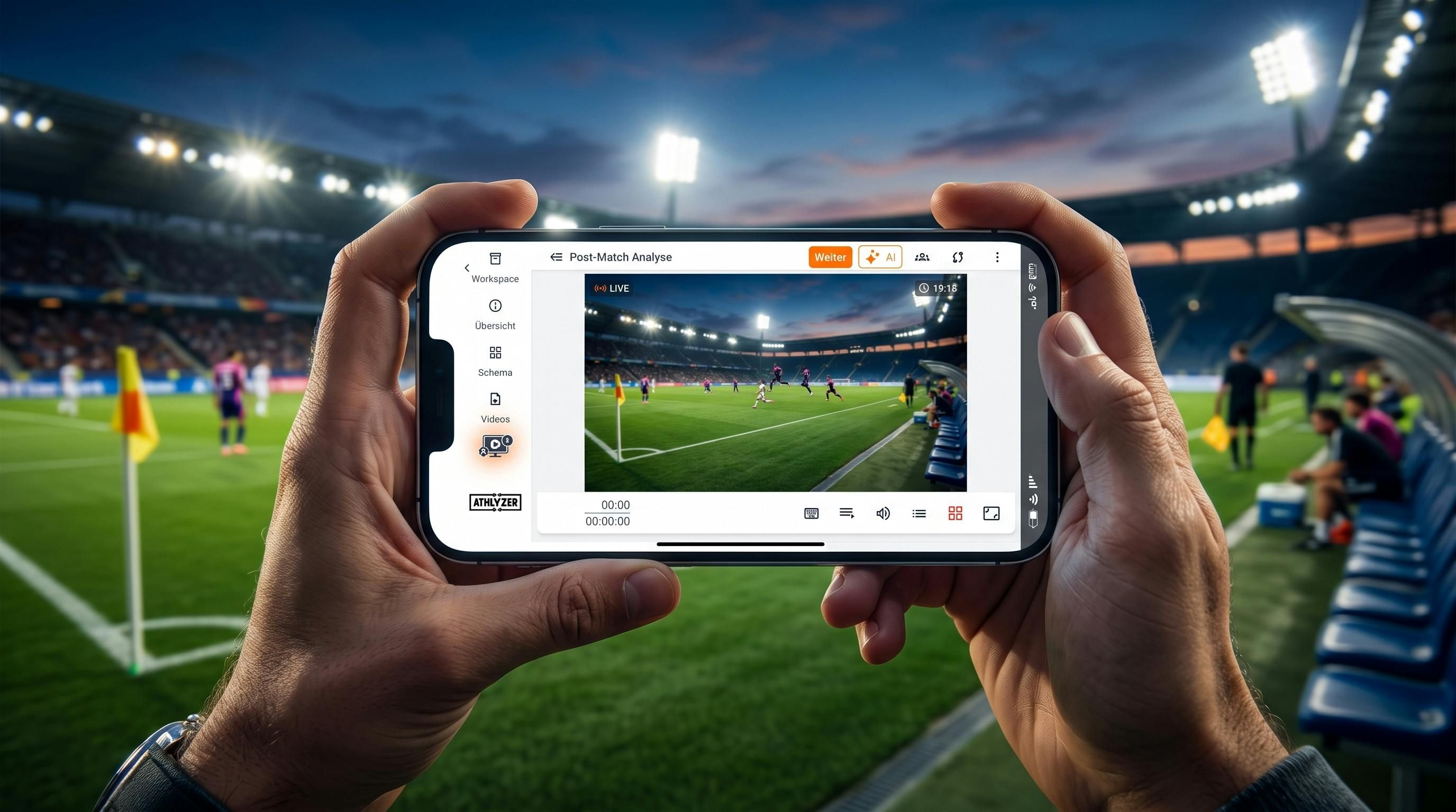 Ein Trainer hält ein Smartphone im Querformat am Spielfeldrand eines Fußballfelds. Auf dem Display ist die miniATHLYZER Videoanalyse-App mit einem Live-Spiel und taktischen Markierungen zu sehen.